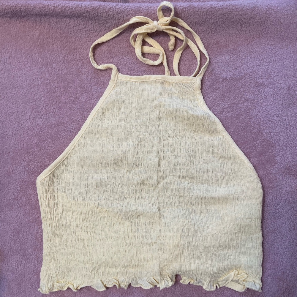 Super cute light yellow halter top w/ adjustable straps. Never worn